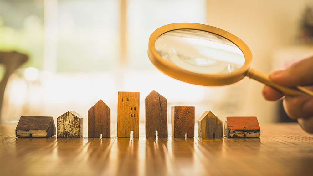 Wooden building pieces person holding magnifying glass